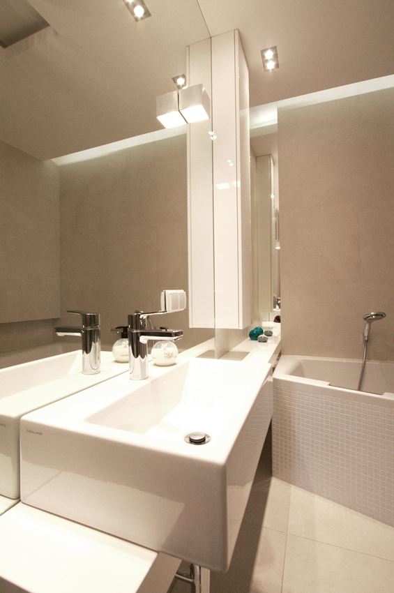 Biała łazienka z dużym lustrem