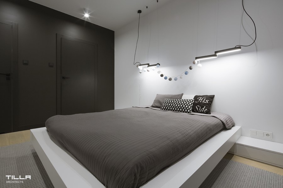 Minimalistyczna sypialnia z nowoczesnym oświetleniem